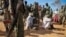 FILE - Alleged members of al-Shabab are blindfolded and guarded at a former police station by soldiers of the Somali National Army (SNA) in Kismayo, southern Somalia, Oct. 3, 2012.