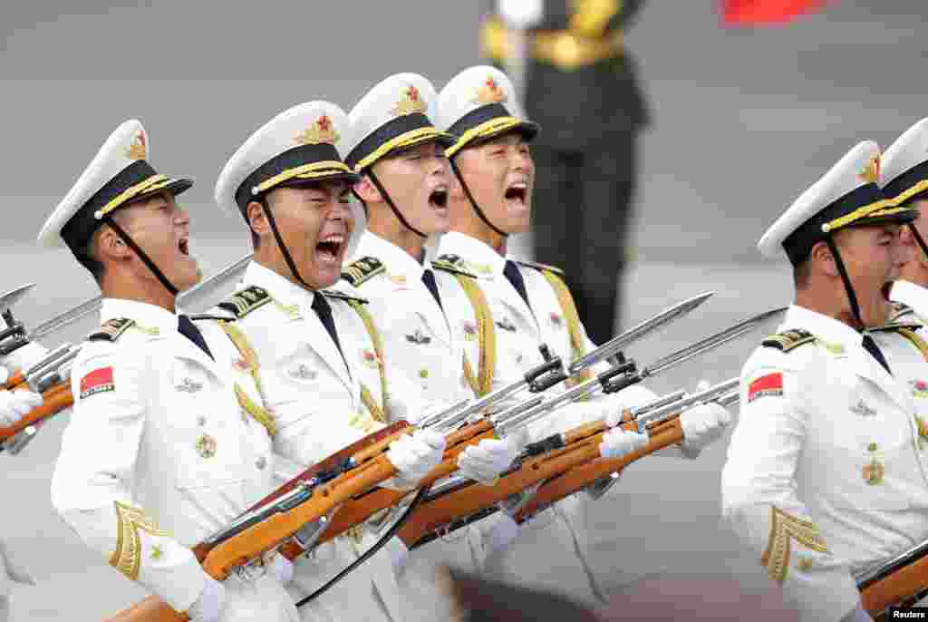 Members of the honor guard shout during a welcoming ceremony for Congo Republic President Denis Sassou Nguesso outside the Great Hall of the People in Beijing, China.