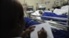 A nurse takes notes at the Kenyatta National hospital after patients drank an illegal alcohol that killed seven people and caused 10 others to go blind, in Nairobi, Kenya, April 9, 2010.