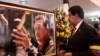 Acting Venezuelan President Nicolas Maduro (R) looks at a photograph of late Venezuelan President Hugo Chavez during the funeral at the military academy in Caracas in this picture provided by Miraflores Palace on March 8, 2013. 