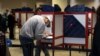 People cast their ballots for the upcoming presidential election as early voting begins in Cincinnati, Ohio, Oct. 6, 2020. 