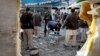 Pakistani security officials examine the site of a suicide attack in Mardan, Pakistan, Dec. 29, 2015.