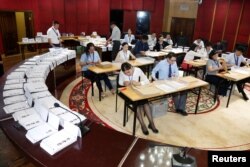 FILE - Election officials count votes in the presidential election in Ulaanbaatar, Mongolia, June 26, 2017.