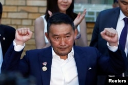 Presidential candidate Khaltmaa Battulga gestures outside a polling station after casting his ballot in Ulaanbaatar, Mongolia, June 26, 2017.