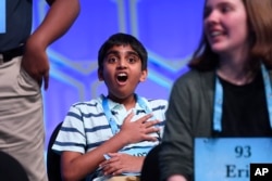 Abhijay Kodali, 12, of Flower Mound, Texas, reacts after learning that he is one of eight co-champions of the 2019 Scripps National Spelling Bee in Oxon Hill, Md., Friday, May 31, 2019. (AP Photo/Susan Walsh)