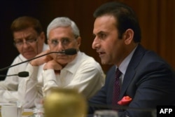 FILE - Afghanistan's then-ambassador to India Shaida Mohammad Abdali, right, speaks at a hotel in Amritsar, Aug. 27, 2015.