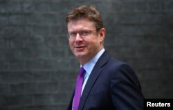 FILE - Britain's Secretary of State for Business Greg Clark arrives at Downing Street, London, Sept. 4, 2018.