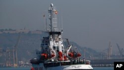 The Open Arms aid boat, of Proactiva Open Arms Spanish NGO, approaches the port of Barcelona, Spain, Wednesday, July 4, 2018. The aid boat sailed to Spain with 60 migrants rescued on Saturday in waters near Libya.