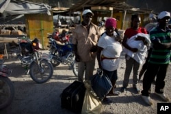 Haitian migrants just deported from Dominican Republic stand on the Haitian side of the border unsure what to do next, in Malpasse, Haiti, June 17, 2015.