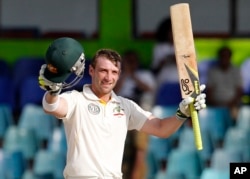 FILE - Australia's batsman Phillip Hughes celebrates after scoring a century.