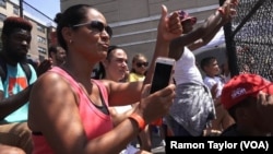 Marilyn Morales cheers on her son Ian from the stands at the Harlem RBI Field of Dreams, New York, Aug. 12, 2016.
