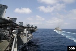 The Nimitz-class aircraft carrier USS Abraham Lincoln (CVN 72) pulls alongside the fast combat support ship USNS Arctic (T-AOE 8) prior to a replenishment-at-sea.