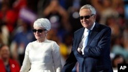 Senate Minority Leader Harry Reid and his wife, Landra, take the stage in sunglasses.