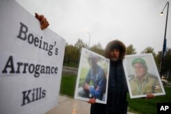 Protester Gene Stilp holds the photographs of victims in the Ethiopian Airlines Flight 302 plane crash, outside Boeing's annual shareholders meeting at the Field Museum in Chicago, April 29, 2019