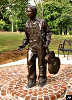 Sculptor Michiel Van der Sommen created this life-size bronze statue, in Tupelo, of Elvis at about age 13