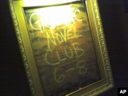 The first word is washed out a bit from the flash reflection, but it reflects a meeting announcement for a book club of folks who read graphic novels in Portland, Oregon.