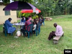 Members of Kirembo village are prepared for the Ebola trial vaccination in Kasese district, Uganda, June 16, 2019. (H. Athumani for VOA)