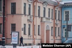 RUSSIA -- A security guard speaks on the phone outside the Concord Catering office in St. Petersburg, February 18, 2018