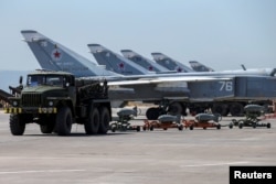 FILE - Russian military jets are seen at Hmeimim air base in Syria, June 18, 2016.