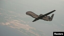 FILE - An Global Hawk drone conducts tests over Maryland in this undated U.S. Navy photo. NATO is purchasing a derivative of the Global Hawk from Northrop Grumman.