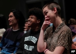 New York University students react while watching the presidential debate between Democratic candidate Hillary Clinton and Republican candidate Donald Trump during a debate watch gathering, Oct. 19, 2016, in New York.