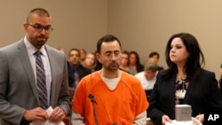 FILE - Dr. Larry Nassar, 54, appears in court for a plea hearing in Lansing, Mich., Nov. 22, 2017. Nasser, a sports doctor accused of molesting girls, pleaded guilty to multiple charges of sexual assault.