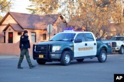 Sheriff's deputy at the entrance to Aztec High School in Aztec, New Mexico, following a deadly shooting on campus, Dec. 7, 2017.