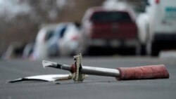 A part from a United Airlines jetliner sits in the middle of Elmwood Street in the street near a home peppered by parts from a plane as it was making an emergency landing at nearby Denver International Airport Saturday, Feb. 20, 2021. (AP Photo/David Zalu