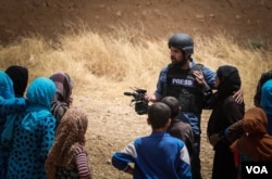 VOA Kurdish service reporter Zana Omar, center, was among those injured in the twin car bomb blasts in Syria, July 27, 2016.