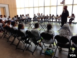 Corporal Sebeke Jefferson leads a Gang Awareness class during Cops Camp in Maryland, July 2015. (J. Taboh/VOA)