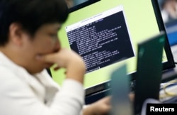 FILE - A student attends a white-hat hackers competition, co-hosted by the Defense Ministry and the National Intelligence Service, at the Korea Military Academy in Seoul, Sept. 29, 2013.