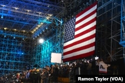 A huge American flag hangs over the media center at the Jacob Javits Convention Center, where the Hillary Clinton campaign is holding its election night rally, in New York, Nov. 8, 2016.