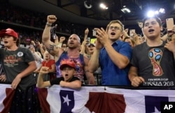 People cheer as President Donald Trump speaks at a rally in Duluth, Minn., June 20, 2018.