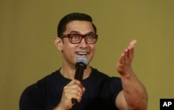 FILE - Bollywood actor Aamir Khan speaks to the media during the poster launch of his film Dangal in Mumbai, India.