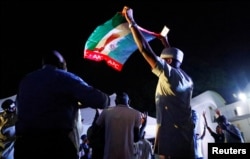 Supporters of Nigeria's President Muhammadu Buhari celebrate at the campaign headquarters of the All Progressives Congress (APC) party in Abuja, Nigeria, Feb. 26, 2019.
