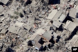 Rescuers search amid rubble following an earthquake in Amatrice, Italy, Aug. 24, 2016.