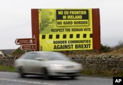 FILE - A car crosses the border from the Irish Republic into Northern Ireland near the town of Jonesborough, Northern Ireland, Jan. 30, 2017. One of the obstacles to a Brexit agreement is this border.