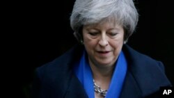 Britain's Prime Minister Theresa May leaves 10 Downing Street for Prime Minister's Questions at the House of Commons, in London, Wednesday Dec. 19, 2018. (AP Photo/Tim Ireland)