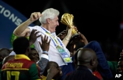 Cameroon coach Hugo Broos, from Belgium, is carried by the players after winning the African Cup of Nations final soccer match between Egypt and Cameroon at the Stade de l'Amitie, in Libreville, Gabon, Sunday, Feb. 5, 2017.