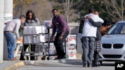 People hug as donations are dropped off at Woodmore Elementary School, Nov. 22, 2016, in Chattanooga, Tenn. A school bus crashed while transporting children home from the school Monday, killing at least six students.