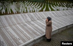 Bida Smajlovic, prays near the Memorial plaque with names of killed in Srebrenica massacre before watching the Trial in Hague Tribunal, in Potocari near Srebrenica, Bosnia and Herzegovina March 24, 2016.