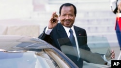 Cameroon President Paul Biya waves to reporters as he gets into his car after a meeting at the Elysee Palace, in Paris, May 17, 2014. Some accuse him of harboring ambitions to remain president for life.
