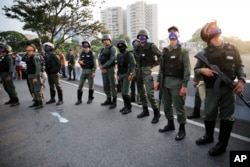 Uprising soldiers stands outside La Carlota air base in Caracas, Venezuela, Tuesday, April 30, 2019.