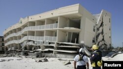 کارکنان گروه جستجو و نجات آژانس مديريت اضطراری فدرال آمريکا درحين مطالعه و برنامه ريزی عمليات نجات در ايالت آلاباما پس از توفان ايوان. ۱۷ سپتامبر ۲۰۰۴