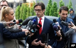 Stevo Pendarovski, a presidential candidate of the ruling coalition led by the Social Democrats, talks to the media outside a polling station after voting in the presidential election in Skopje, North Macedonia, May 5, 2019.