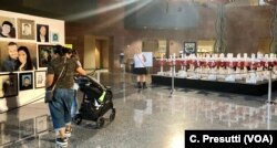 Elizabeth West, center, looks at the 58 crosses commemorating the people who died in the Oct. 1, 2017, shooting. It was the largest shooting massacre by one individual in U.S. history. West and her daughter were at the concert.