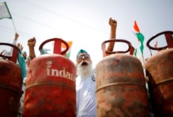 A farmer shouts slogans during a protest against the hike in fuel prices, at the Delhi-Uttar Pradesh border in Ghaziabad, India.