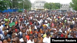 FILE - People march during a protest to voice discontent toward the presidency of former footballer George Weah, whose policies they see as having failed to curb economic decline and mitigate corruption, in Monrovia, Liberia, June 7, 2019. 
