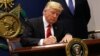 US President Donald Trump signs an executive order to impose tighter vetting of travelers entering the United States, at the Pentagon in Washington, Jan. 27, 2017. 