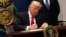 US President Donald Trump signs an executive order to impose tighter vetting of travelers entering the United States, at the Pentagon in Washington, Jan. 27, 2017. 